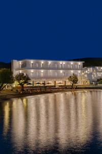 a large building next to a body of water at Boutique ''Di Mare'' Hotel & Suites in Posidhonía