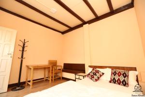 a bedroom with a bed and a table and a desk at Aarya Chaitya Inn in Kathmandu