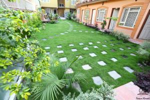 a garden with stepping stones in the grass at Aarya Chaitya Inn in Kathmandu