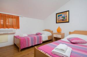 Postel nebo postele na pokoji v ubytování Apartments Judita
