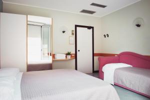 Postel nebo postele na pokoji v ubytování Hotel Junior