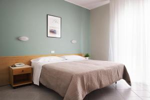 Postel nebo postele na pokoji v ubytování Hotel Junior