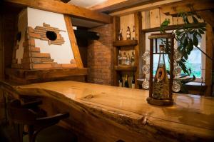 a wooden bar with a bottle on top of it at Cabarkapa Guesthouse in Žabljak