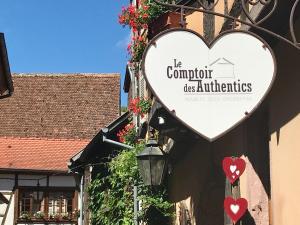 a heart sign on the side of a building at Les Authentics - La Maison d'Amélie in Riquewihr