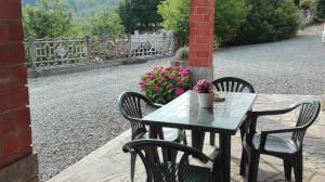 a table and chairs with flowers on a patio at Casa Statiella in Acqui Terme