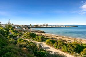 a view of a beach with a pier in the distance at Quest Fremantle in Fremantle