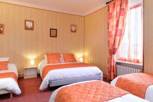 a hotel room with three beds and a window at Logis Hôtels Restaurant Le Dauphin in Salbris