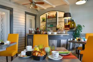 a dining room with a table and chairs and a bar at Logis Hôtels Restaurant Le Dauphin in Salbris