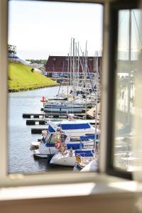 a group of boats docked in a marina at Astra Hotel in Klaipėda