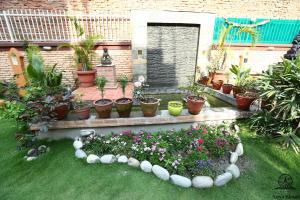 a garden with a bunch of plants and flowers at Aarya Chaitya Inn in Kathmandu