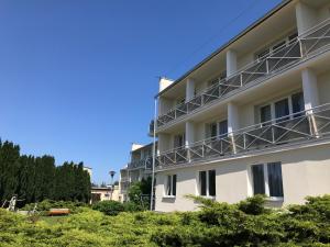 a building with balconies on the side of it at Hotel *** NAT Jarosławiec in Jarosławiec