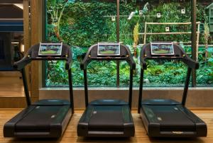 a group of three treadmill machines in front of a window at Elite World Europe Hotel in Istanbul