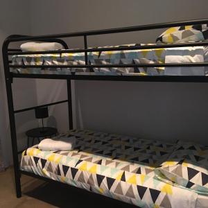 a bedroom with a bunk bed with towels on it at The Lane, Doubleview in Perth