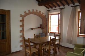 a dining room with a wooden table and chairs at Marinho in Cavo