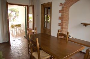 a dining room with a wooden table and chairs at Marinho in Cavo +8 photos