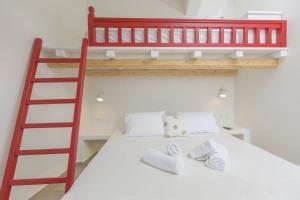 a bedroom with a bunk bed with a ladder at Amalthia Luxury Studios in Naxos Chora
