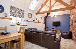 a living room with a couch and a table at Holtby Grange Cottages in York