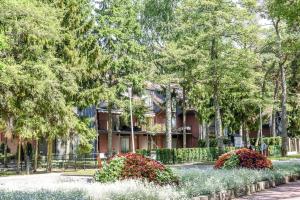 a building with a garden in front of it at Corona Maris in Palanga