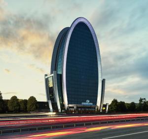 a large building with a curvedraper on the side of a highway at Elite World Europe Hotel in Istanbul