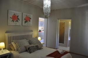 a bedroom with a bed and a chandelier at Sedgefield Island Villa in Sedgefield