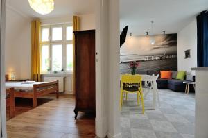 a living room with a couch and a table at Victus Apartamenty, Apartamenty Adams in Sopot