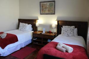 A bed or beds in a room at The Hamlet Country Lodge