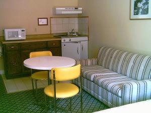 a kitchen with a couch and a table and chairs at Picket Fence Motel in Saint Andrews