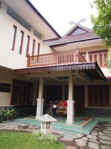 a house with a balcony on top of it at Balai Melayu Hotel in Yogyakarta