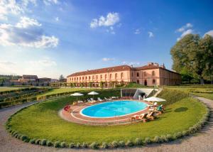 a resort with a swimming pool in front of a building at Albergo dell'Agenzia in Bra