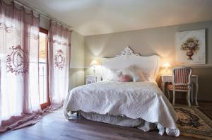 a bedroom with a white bed with a child sleeping on it at CR BnB Rozzano in Rozzano