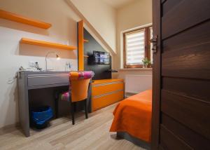 a bedroom with a sink and a desk and a bed at Noclegi i restauracja Zajazd Pod Skałą in Jasło +78 photos