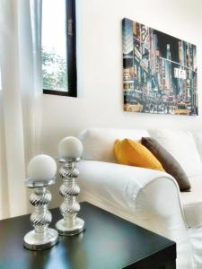 a living room with a white couch and a table at Vivo Apartments in Athens