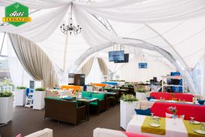 a tent with tables and chairs in a restaurant at Park Hotel in Karagandy