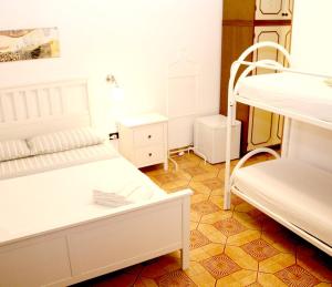 a room with two bunk beds and a table at B&B L' Aranceto in San Donaci