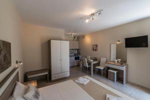 a living room with a kitchen and a dining room at DeniaStella villas in Skala Potamias