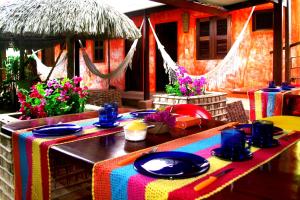 a table with a colorful table cloth on top at Pousada Ibiscus in Jericoacoara