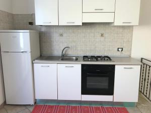 Kuchyň nebo kuchyňský kout v ubytování B&B Porticella