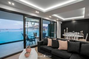 a living room with a couch and a view of the ocean at Pineapple Seaside Suite in Zakynthos Town