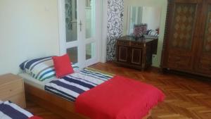 a bedroom with a bed and a window and a table at Horváth Apartmanház in Kaposvár