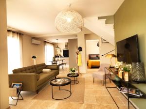 a living room with a couch and a table at Les Loges En Provence "L'Échappée" in Bédoin