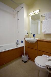 a bathroom with a sink and a tub and a toilet at The Fairway in Barnsley