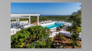 a villa with a swimming pool and views of the desert at Milatos Village Cretan Agrotourism Hotel in Milatos