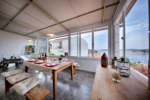 a living room with a table and large windows at Bellevue Apartment Hvar in Hvar