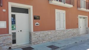a building with two doors on the side of it at THE BEST ROOMS & APARTMENTS - Parcheggia gratis sotto casa ed entra - in Mazara del Vallo