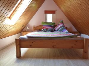a bed with a stuffed animal sitting on it in a attic at Ferienhaus Katharina in Nothweiler
