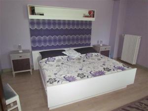 a small bedroom with a bed and two night stands at Ferienwohnung Oppermann in Arholzen