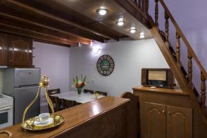 a kitchen with a table and a microwave and a table with a table at Aronia Villa in Imerovigli