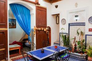 una habitación con mesa y sillas en una casa en Dar Nineta en Fez