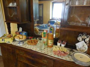 a kitchen counter with food on top of it at Affitta Camere La Dolce Sosta in Perosa Argentina +18 photos