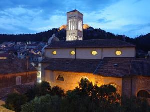 a building with a clock tower on top of it at City Center Room Olivia in Hvar